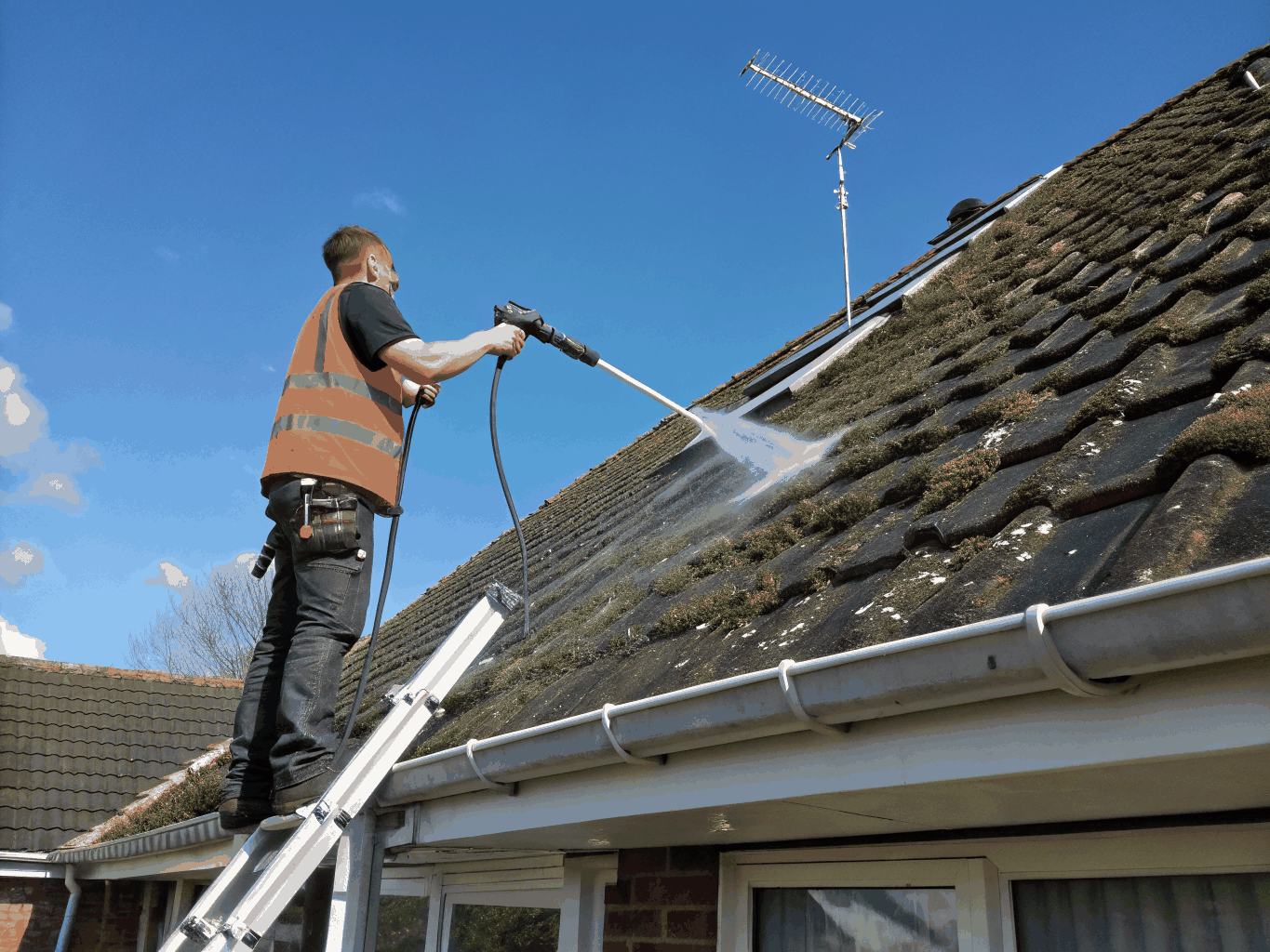High reach vacuum equipment clearing debris from multi-storey roof gutters